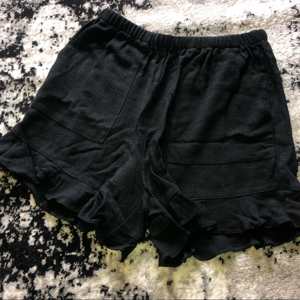 black linen ruffled shorts.